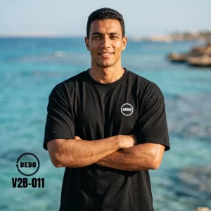 DEDO V2B-011 oversized streetwear t-shirt with a front circular logo by the sea.