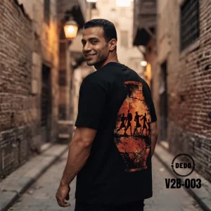 DEDO black oversized T-shirt with Egyptian-inspired back graphic, worn in an old Egyptian street