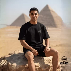DEDO V2B-003 black oversized T-shirt with minimal chest logo, styled in front of the Giza Pyramids