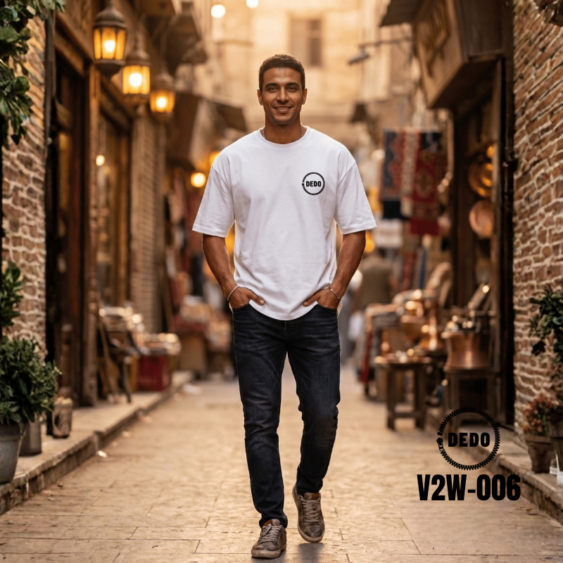 DEDO V2W-006 white oversized T-shirt with circular logo styled in a historic street