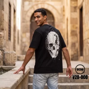 Model wearing DEDO V2B-008 black oversized cyber skull t-shirt posing in historic courtyard