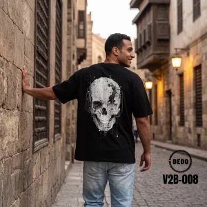 Back view of man wearing DEDO V2B-008 black oversized cyber skull t-shirt in historic street